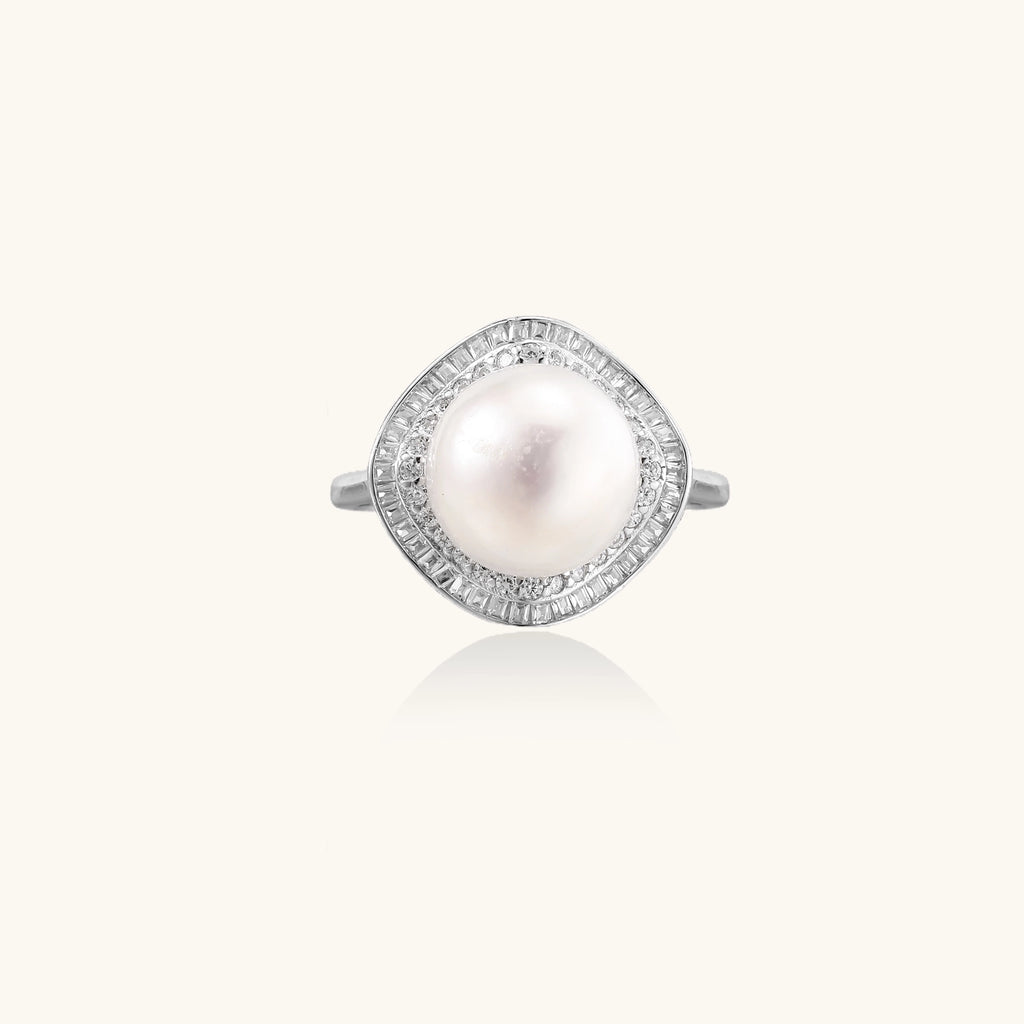 Sterling silver ring with 11mm freshwater pearl surrounded by double diamond halo on white background.