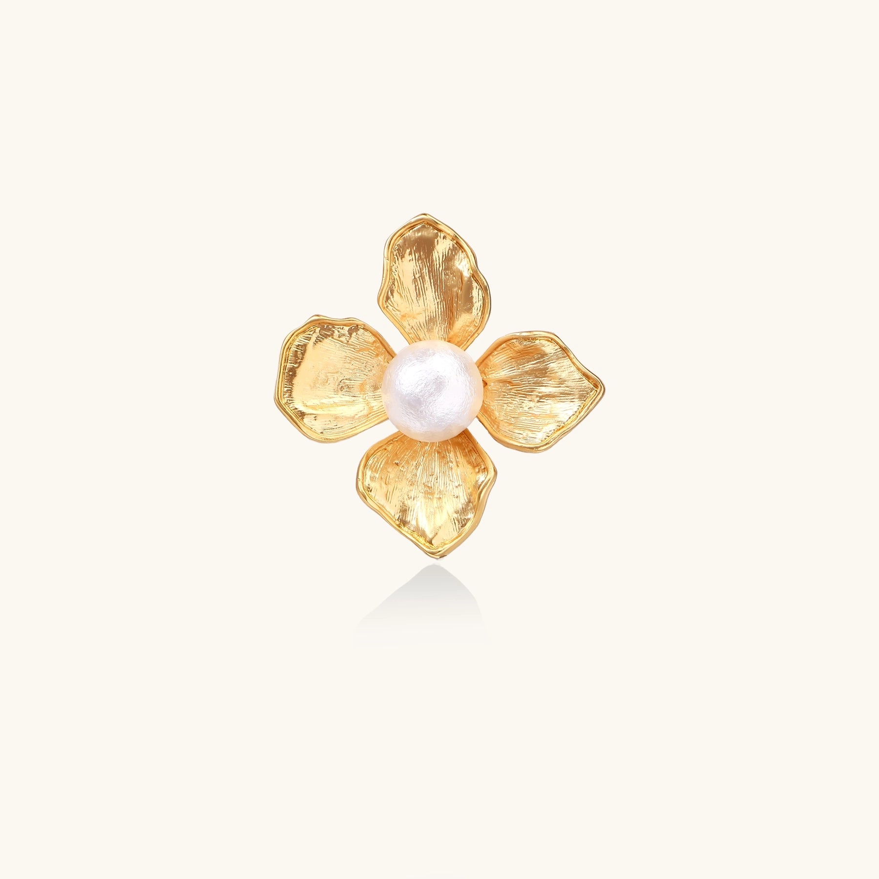 Gold-plated brass ring with dimensional 5-petal flower design and white cotton pearl center on neutral background.