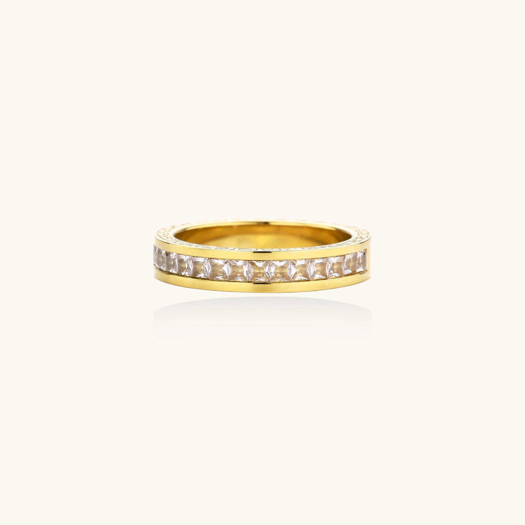 14K gold plated ring with channel-set zirconia stones and Greek key pattern engraved on sides on white background